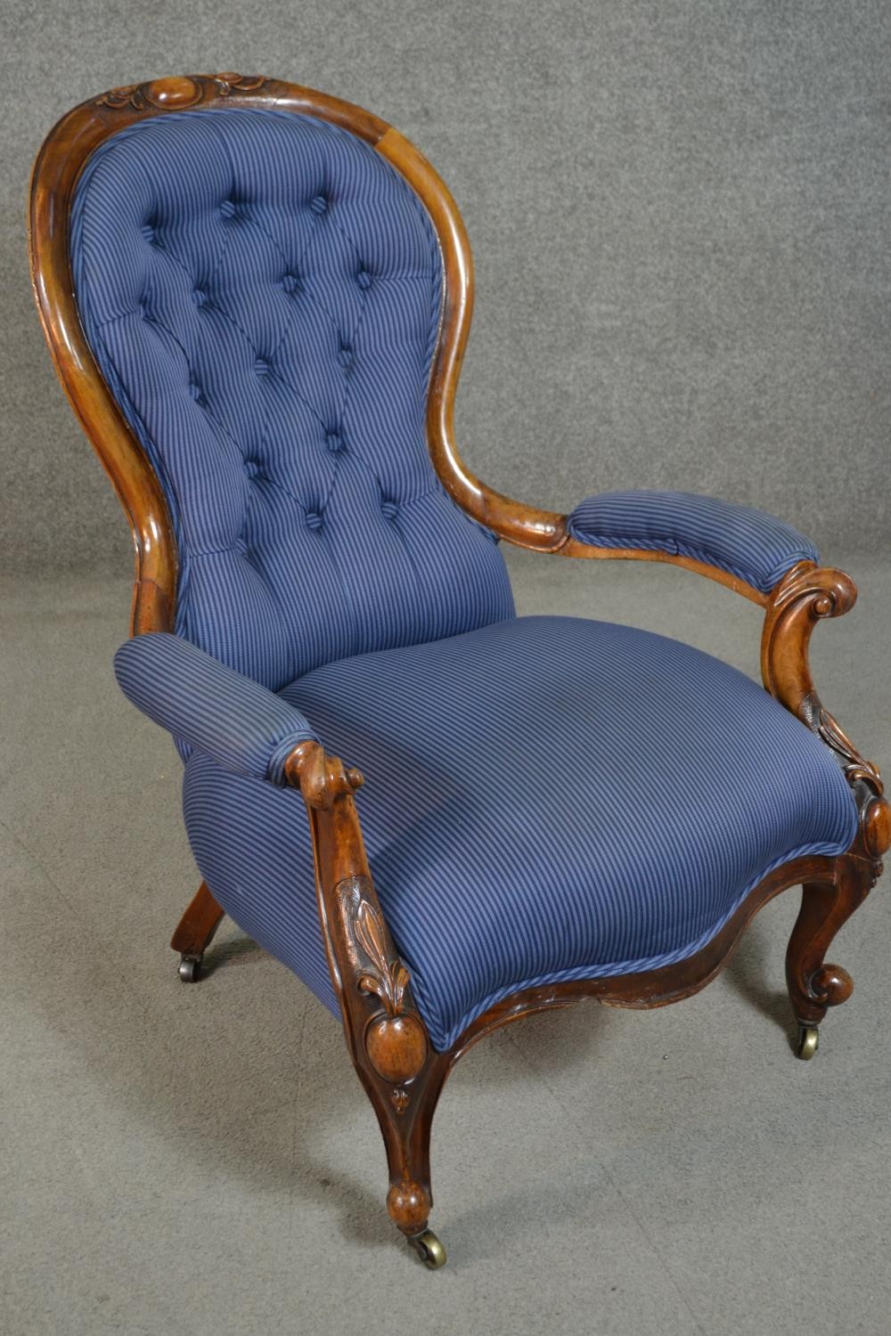 A Victorian walnut spoon back open armchair, upholstered in striped blue fabric, to the arms, seat - Image 2 of 7
