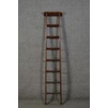 A late 19th to early 20th century ladder, with a rectangular top over seven rungs. H.167cm