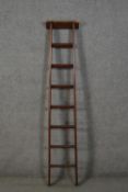 A late 19th to early 20th century ladder, with a rectangular top over seven rungs. H.167cm