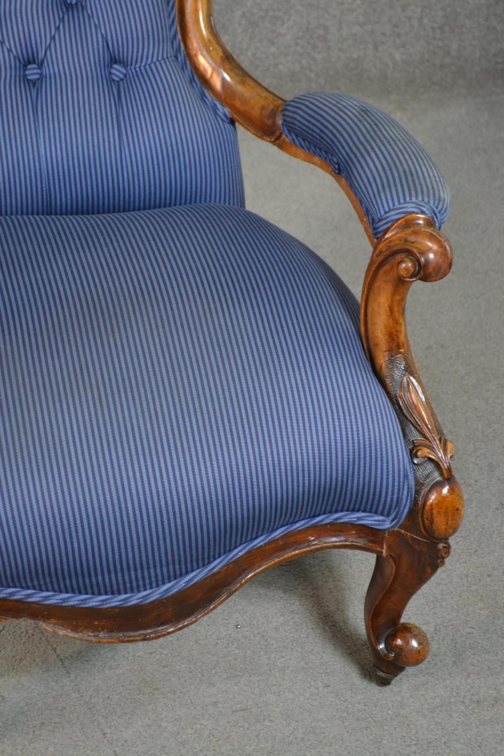 A Victorian walnut spoon back open armchair, upholstered in striped blue fabric, to the arms, seat - Image 5 of 7
