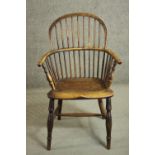 A 19th century ash hoop back Windsor armchair, with an elm seat, on turned legs joined by an H