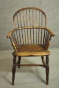 A 19th century ash hoop back Windsor armchair, with an elm seat, on turned legs joined by an H