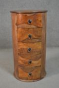 A contemporary Eastern hardwood cylindrical bedside chest, of five drawers. H.81 Diam.44cm