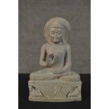 A carved Oriental hardstone Buddha in the lotus position. H.33.5 W.22 D.8cm