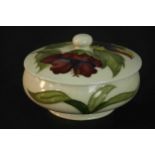 A Moorcroft pottery hibiscus pattern, cream ground, powder bowl and cover. Stamped Moorcroft to