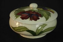 A Moorcroft pottery hibiscus pattern, cream ground, powder bowl and cover. Stamped Moorcroft to
