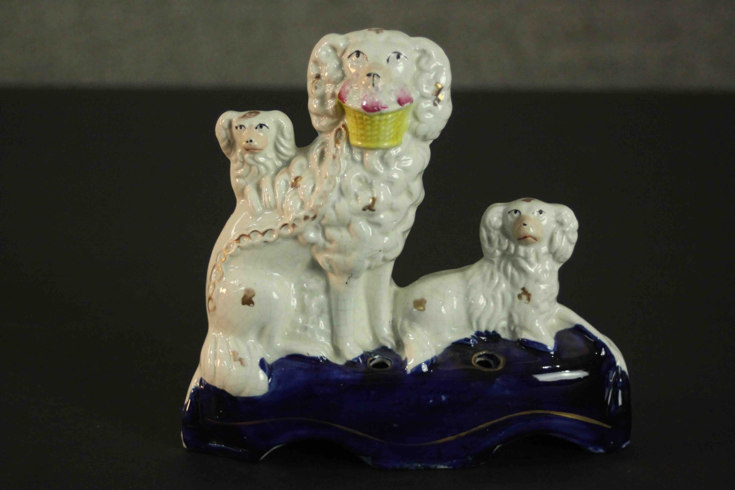 A Staffordshire flatback pottery pen or quill holder, in the form of three spaniels, on an oval