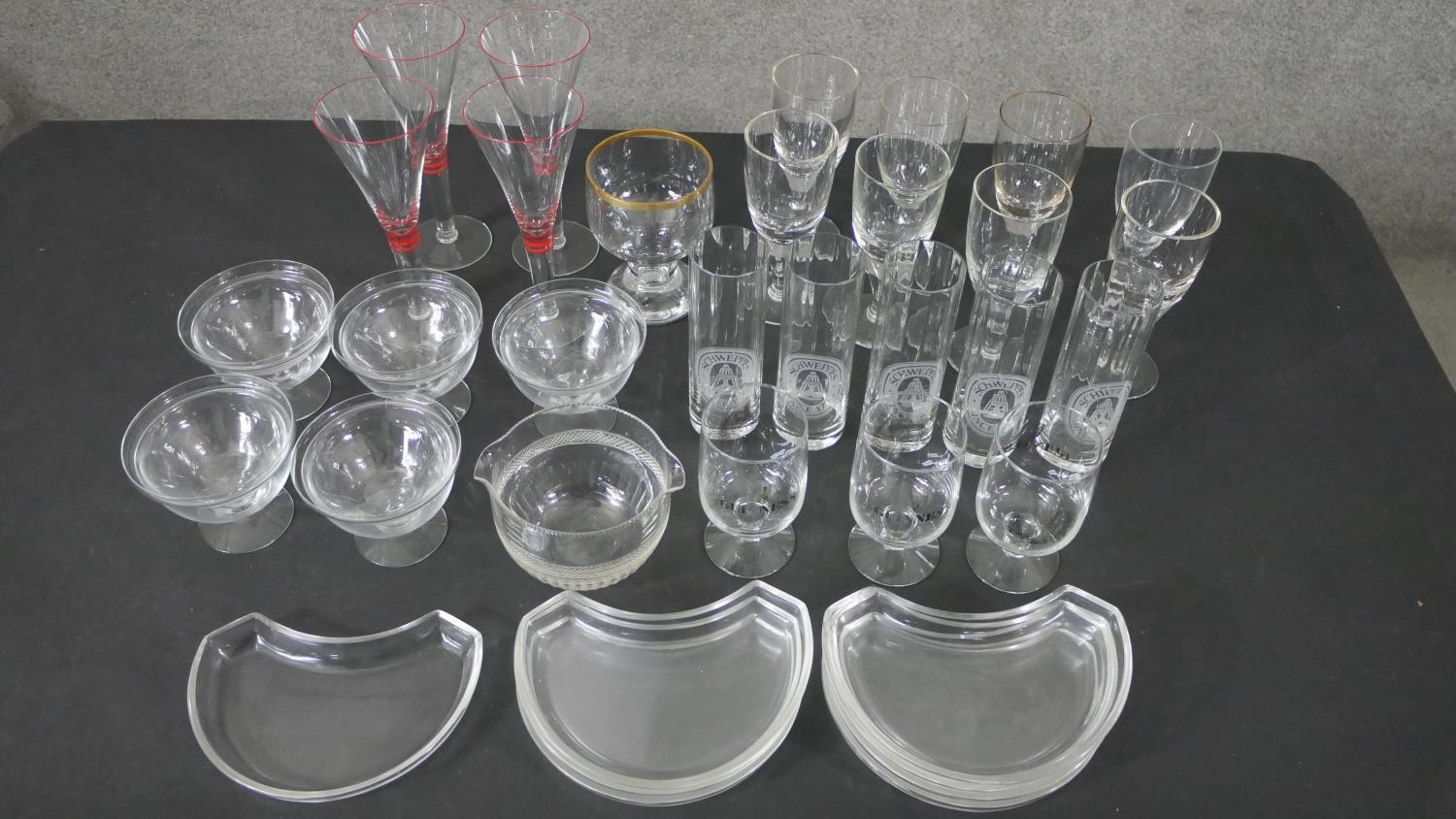 A collection of glassware, including a set of five vintage Schweppes glasses, three Guinness