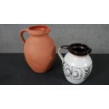 Two C H Branham Barum art pottery jugs, one terracotta with clear glaze inside ad one with a