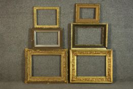 A collection of six picture frames, including four carved giltwood and gesso frames with various