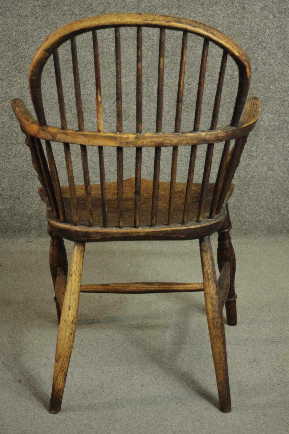 A 19th century ash hoop back Windsor armchair, with an elm seat, on turned legs joined by an H - Image 4 of 6