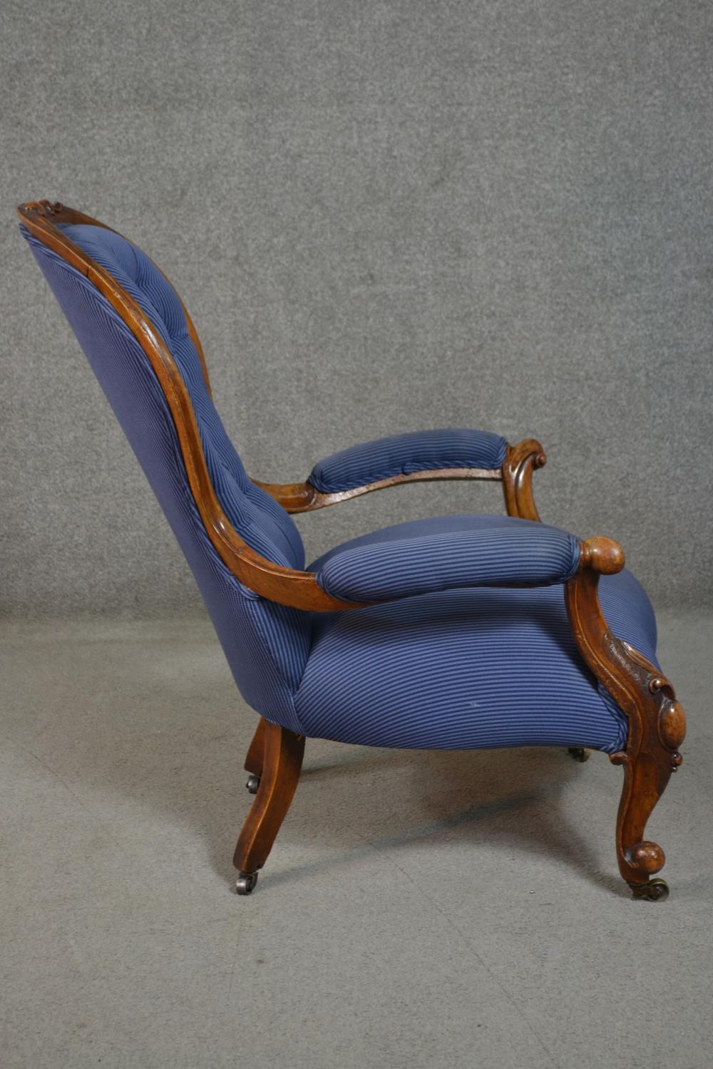 A Victorian walnut spoon back open armchair, upholstered in striped blue fabric, to the arms, seat - Image 3 of 7