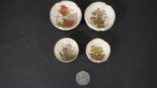 Four antique Japanese Satsuma ware hand painted miniature bowls, each with a different floral design