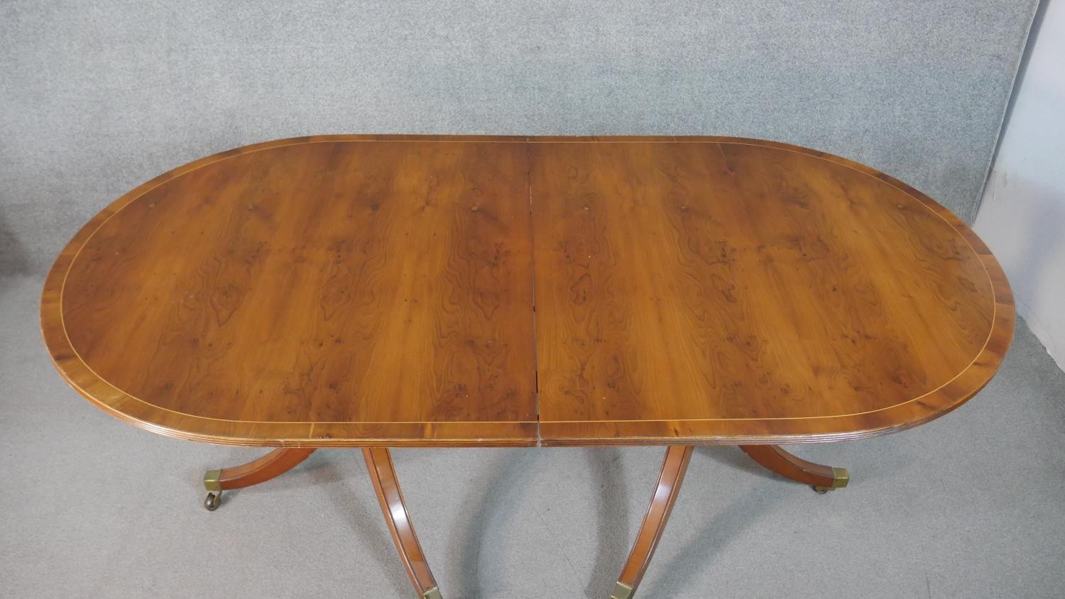 A George III style yew wood D-end dining table, with a cross banded top and additional leaf, on - Image 8 of 9