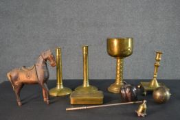 A collection of metal ware including a brass goblet, a pair of early 20th century candlesticks, a