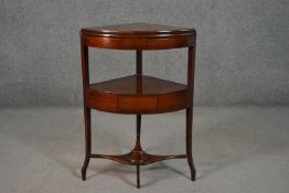A George III mahogany corner washstand, of bow front, with a fold over top, over a single drawer, on