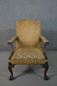 A possibly Irish mahogany Gainsborough style open armchair, upholstered in patterned foliate fabric,