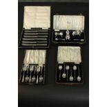 A collection of cased silver, including a set of six silver coffee spoons, a set of six acrylic
