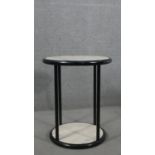 A contemporary circular occasional table, with a white marble top and undertier on an ebonised