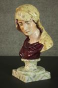 An early 19th century Staffordshire pottery bust of the Virgin Mary, the socle and plinth painted to