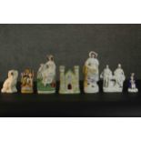 A collection of seven 19th century Staffordshire pottery figures, including a castle form spill