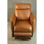 A contemporary tan leather electric reclining armchair, possibly Natuzzi, with instructions. In good