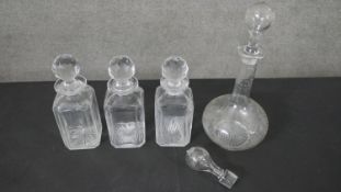 A collection of cut crystal and etched glass decanters, one with an engraved fern leaf design. H.