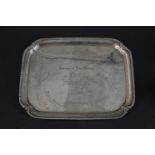 A sterling silver tray with engraved inscription and signatures. It has beaded detailing to the edge