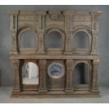 An Indian carved hardwood shrine, with two tiers of recesses, formerly containing mirror plates, two