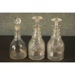 Three 19th century hand cut glass decanters, one with a disc shaped stopper. H.23 Dia.8cm.