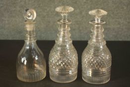 Three 19th century hand cut glass decanters, one with a disc shaped stopper. H.23 Dia.8cm.