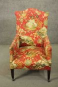 A circa 1900 hump back armchair, upholstered in a Chinoiserie fabric on a salmon ground, on mahogany