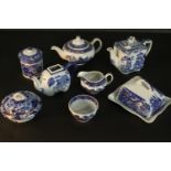 A collection of eight pieces of blue and white transferware pottery, including lidded pots, butter