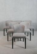 A set of six contemporary dining chairs, upholstered in grey fabric, on ebonised tapering square