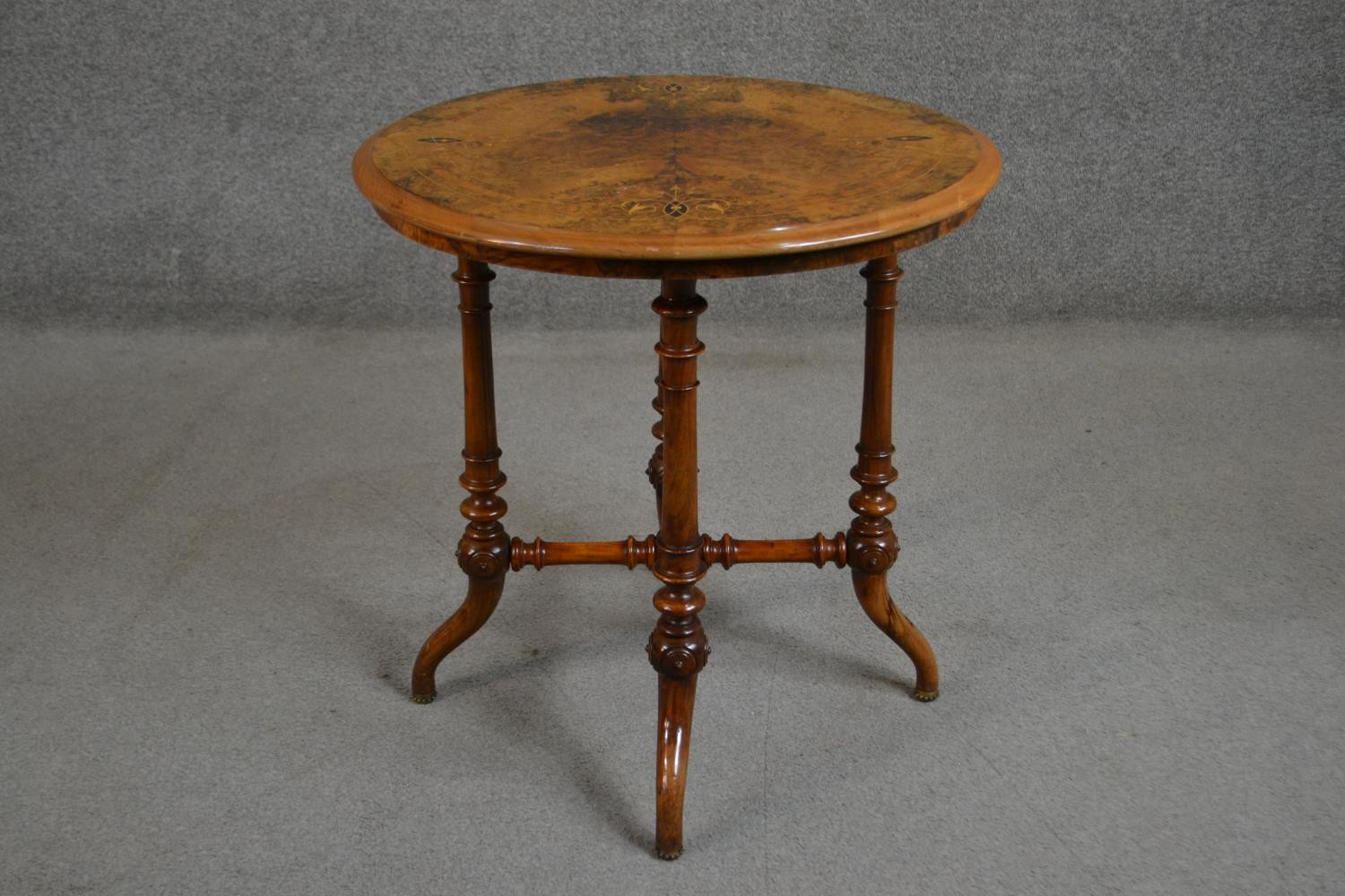 A Victorian circular figured walnut and marquetry inlaid occasional table, on turned legs joined