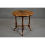 A Victorian circular figured walnut and marquetry inlaid occasional table, on turned legs joined