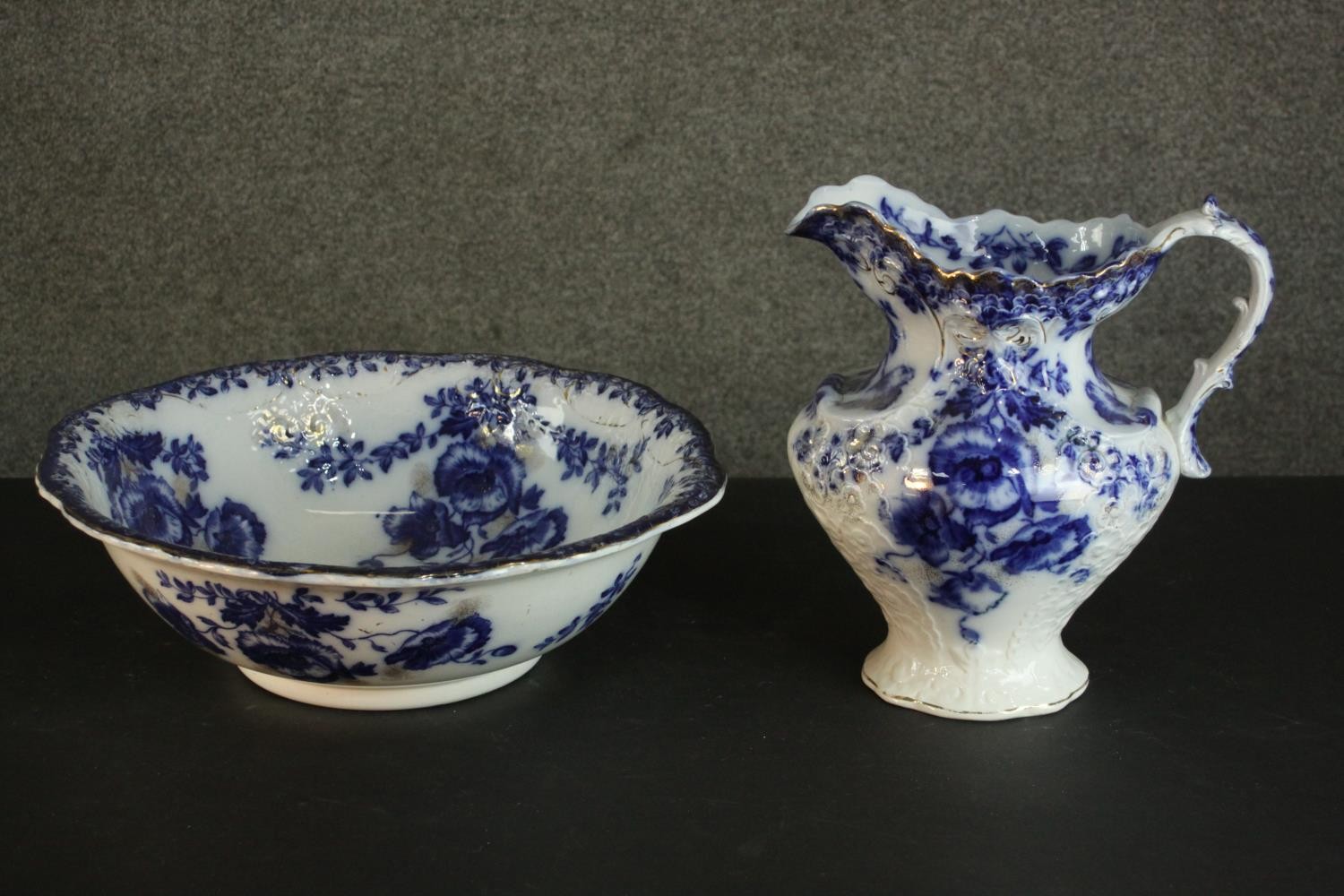 A Ford & Sons pottery 'Laurel' pattern china wash jug and basin, with blue transfer printed poppies.
