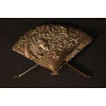 A Meiji period Shakudō ware gilt bronze miniature model of a Japanese fan with relief stork and