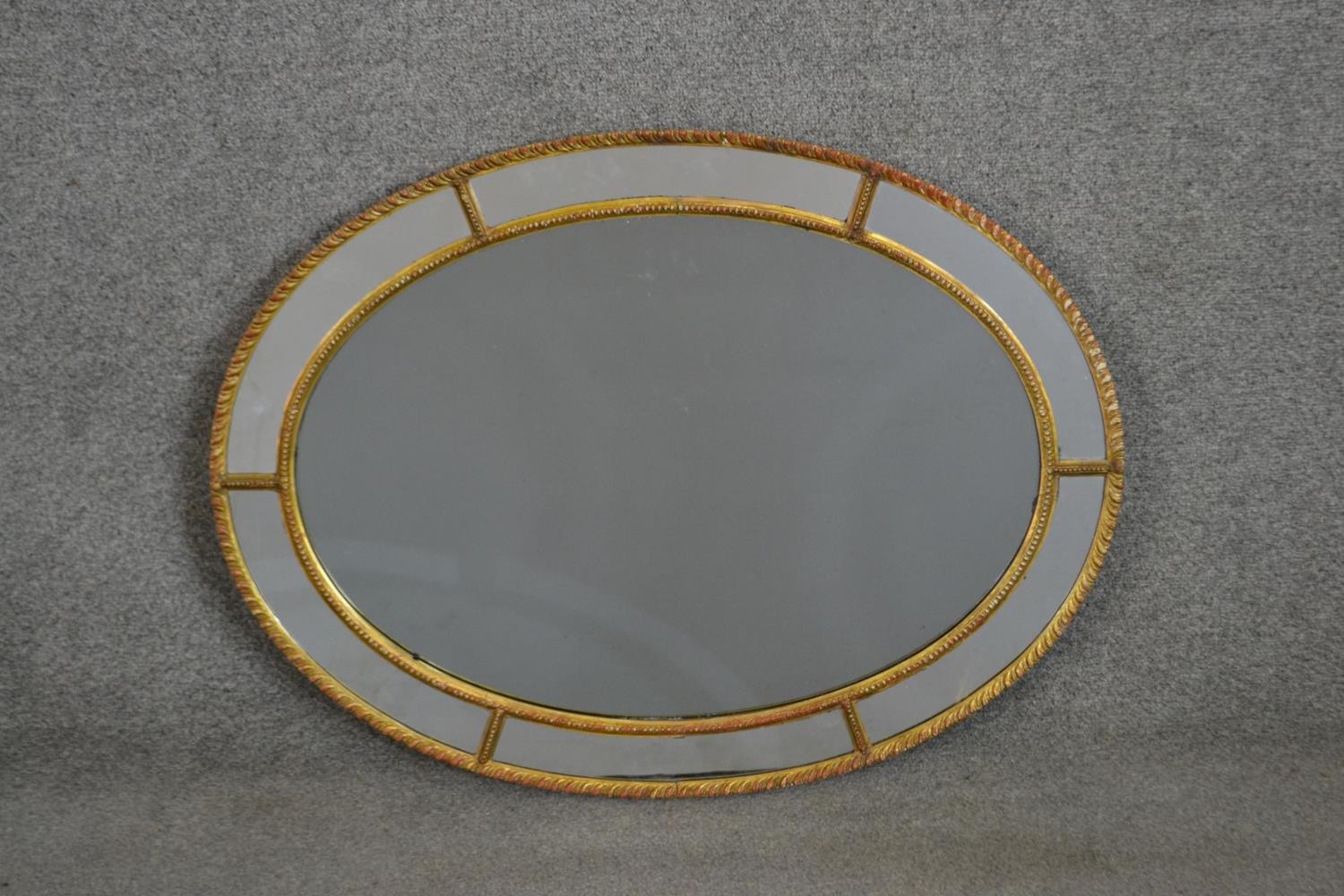 A 19th century Venetian style oval wall mirror with rope design border. H.81 W.60cm