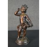 A spelter figure of a classical style putti with a basket of flowers. H.37cm
