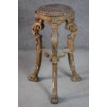 A late 19th century Italian carved wood jardiniere stand, with a circular top, on three ornately