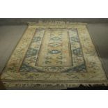A Beige ground handmade Turkish Milas carpet. L.235 W.162cm.