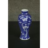 A Chinese 19th century blue and white prunus design porcelain vase, Kangxi mark to base. H.27 Dia.