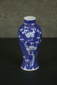 A Chinese 19th century blue and white prunus design porcelain vase, Kangxi mark to base. H.27 Dia.