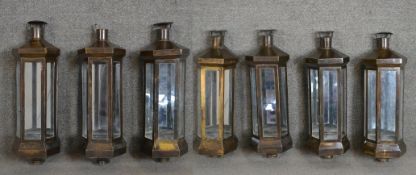 A set of seven brass and plate wall lanterns with angular design. (for candles) H.64 W.21cm