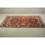 A red ground hand made Persian Kurdish rug. H.204 W.134cm.
