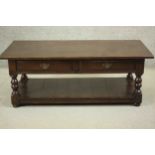 A reproduction oak coffee table in the antique style, of rectangular form, with two short drawers,