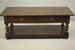 A reproduction oak coffee table in the antique style, of rectangular form, with two short drawers,