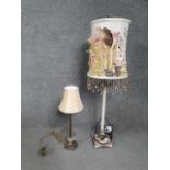 Two contemporary lamps, including one gilt with a lobed glass section and a cream shade. H.83 W.