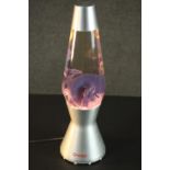 A 1960s style Mathmos lava lamp, the oil contained inside of purple hue, bearing label 'Mathmos,